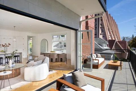 a living room with furniture and a floor to ceiling window