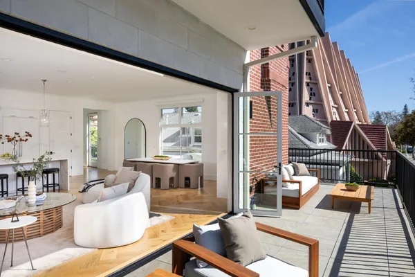 a living room with furniture and a floor to ceiling window