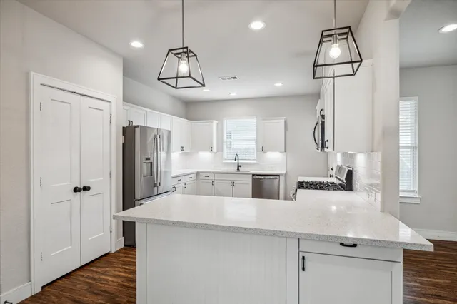a kitchen with refrigerator and cabinets