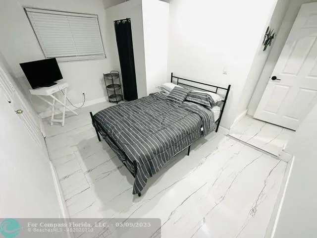 a bathroom with a toilet and a mirror