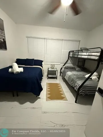 a bedroom with furniture and wooden floor