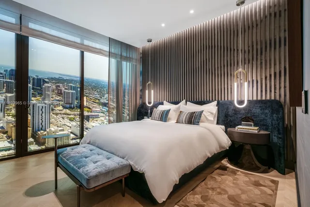 a bedroom with bed and glass door