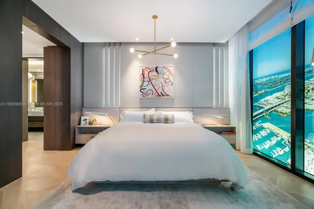 a bedroom with a bed and a large window