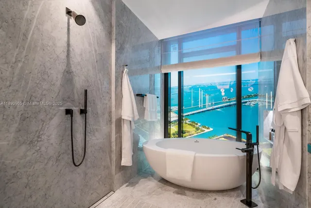a bathroom with a tub and a shower