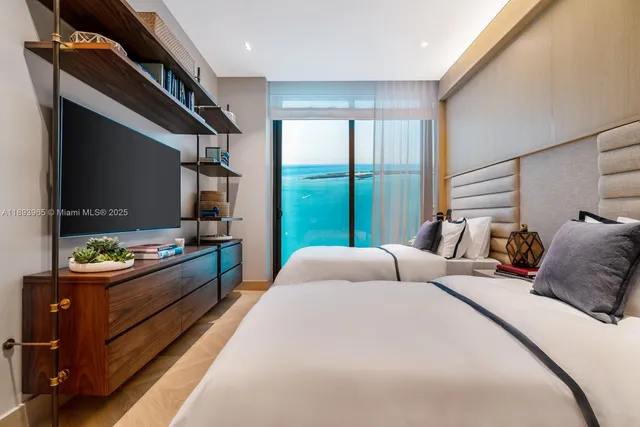 a bed room with a bed and a television