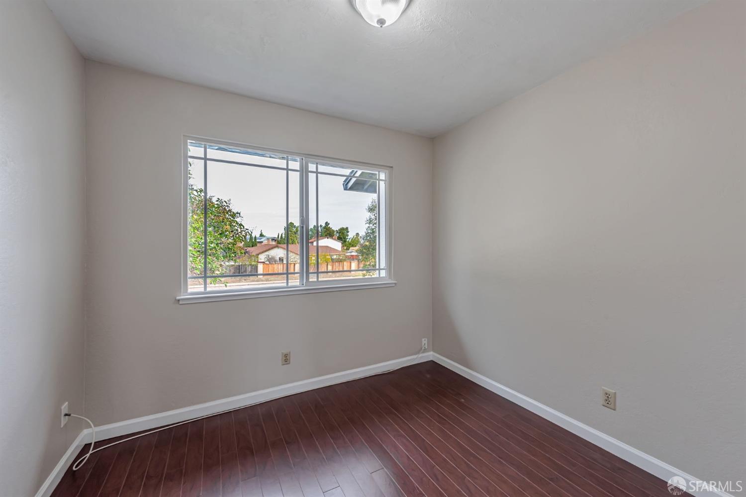 4346 Solano Way Union City, CA 94587 - Photo 22 of 40 a view of an empty room with wooden floor and a window