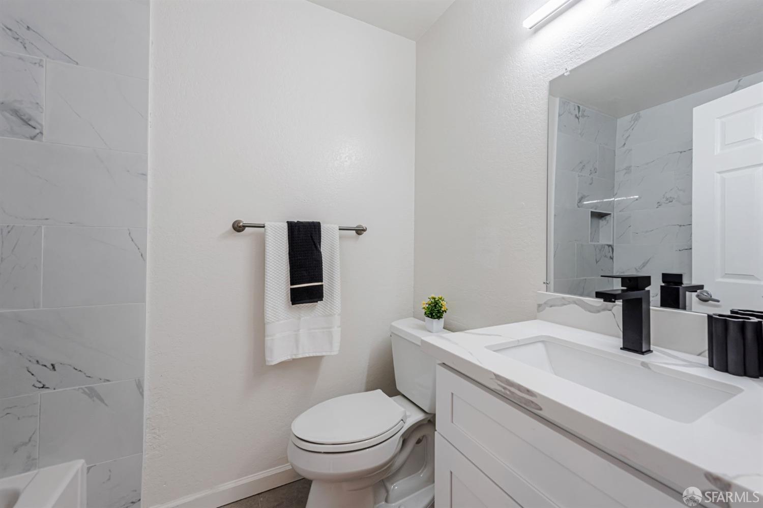 4346 Solano Way Union City, CA 94587 - Photo 25 of 40 a bathroom with a sink toilet and mirror