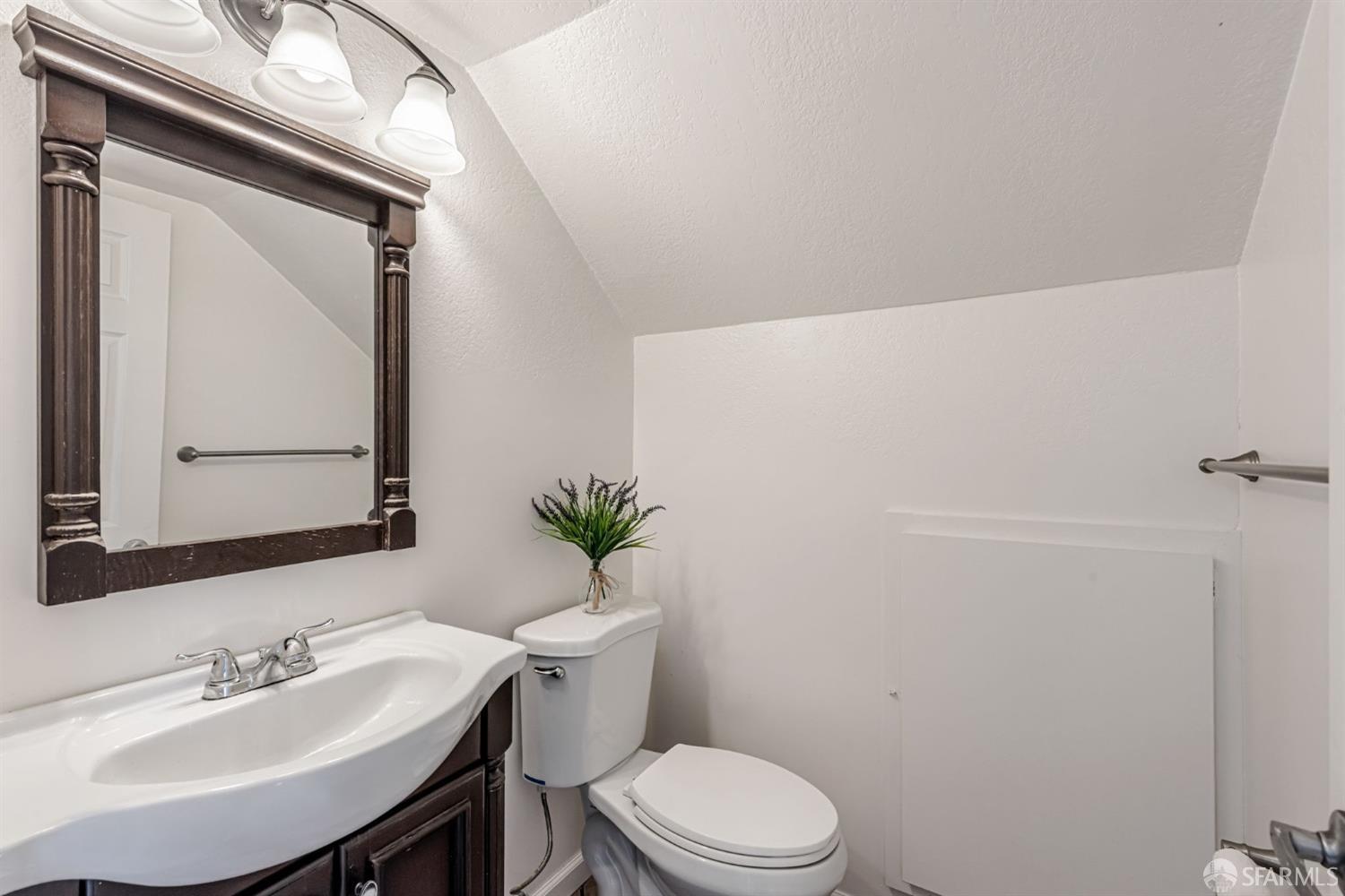 4346 Solano Way Union City, CA 94587 - Photo 29 of 40 a bathroom with a toilet a sink and mirror