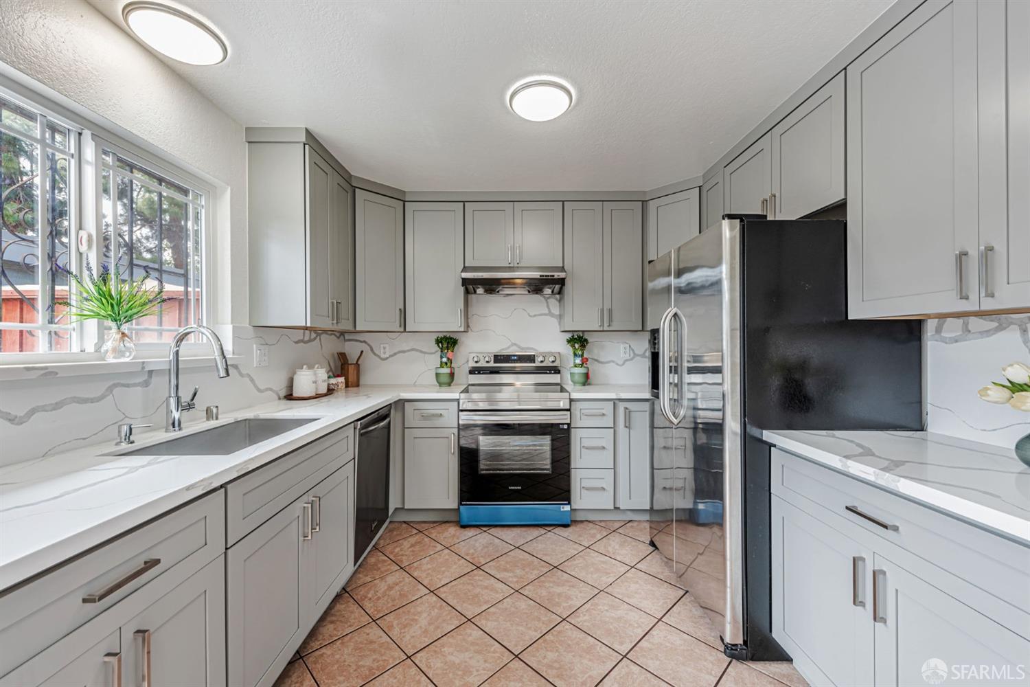 4346 Solano Way Union City, CA 94587 - Photo 7 of 40 a kitchen with a sink stove and refrigerator