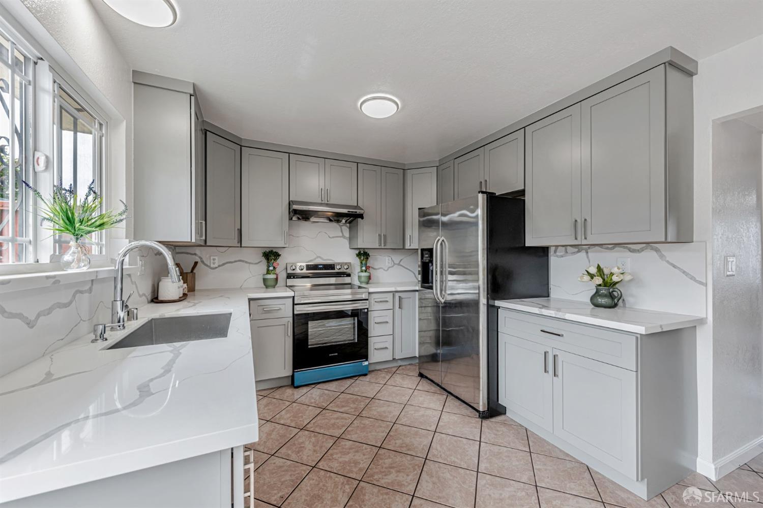 4346 Solano Way Union City, CA 94587 - Photo 8 of 40 a kitchen with a sink stove and refrigerator