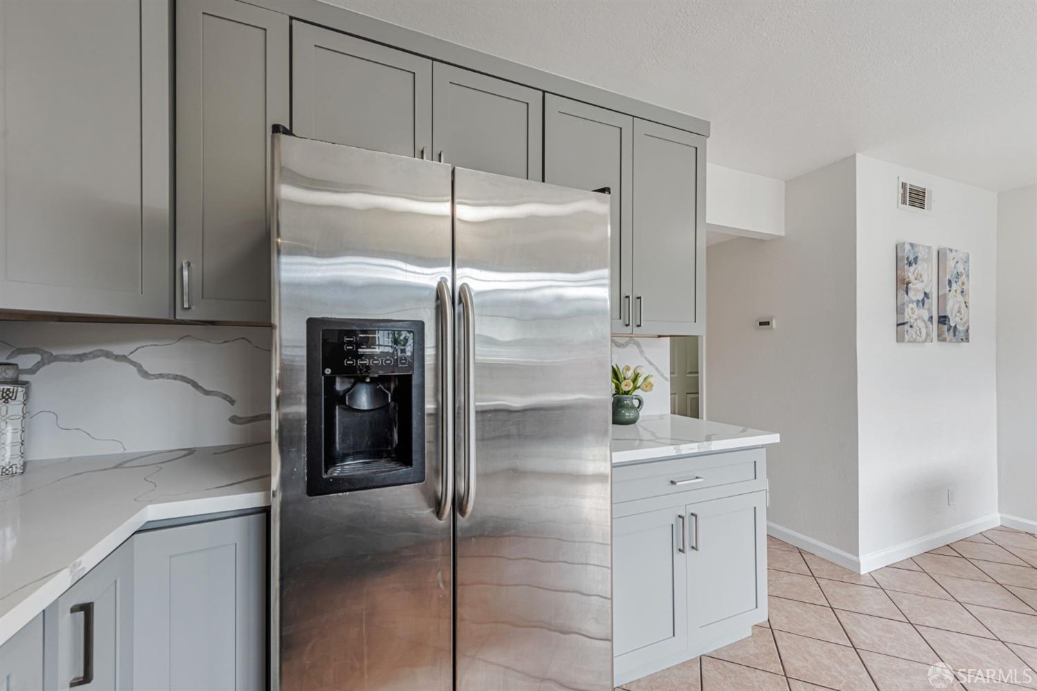4346 Solano Way Union City, CA 94587 - Photo 10 of 40 a kitchen with a refrigerator and white cabinets