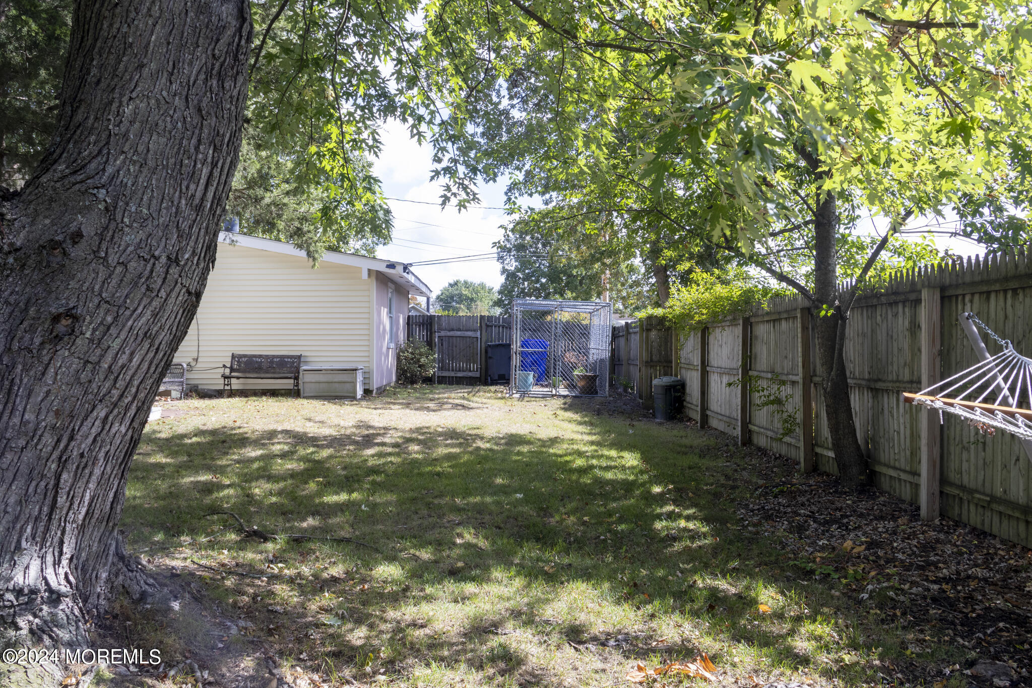 448 Cornell Drive Brick, NJ 08723 - Photo 22 of 28 a view of a backyard with large trees and a barn