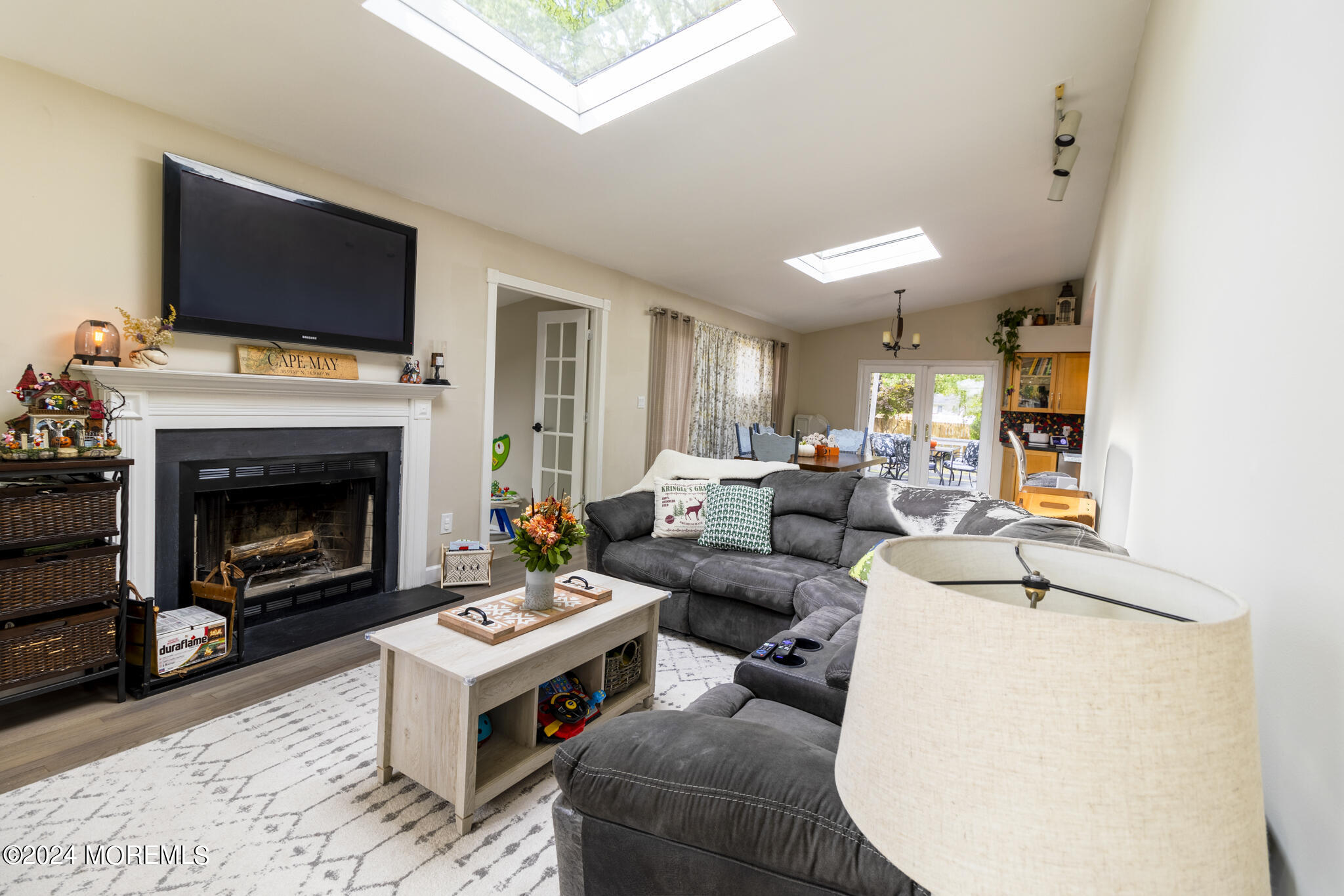 448 Cornell Drive Brick, NJ 08723 - Photo 8 of 28 a living room with furniture a flat screen tv and a fireplace