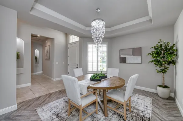 a view of a dining room with furniture and chandelier