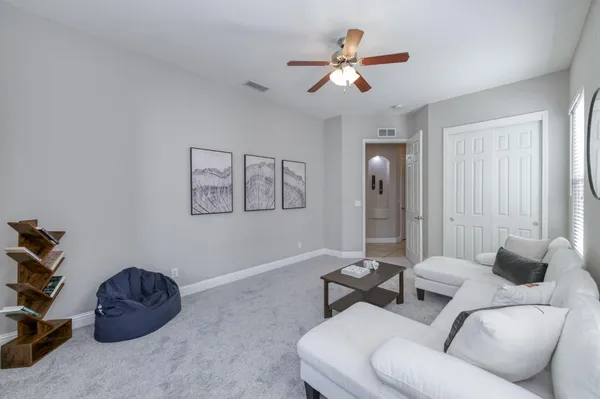 a living room with furniture and a chandelier