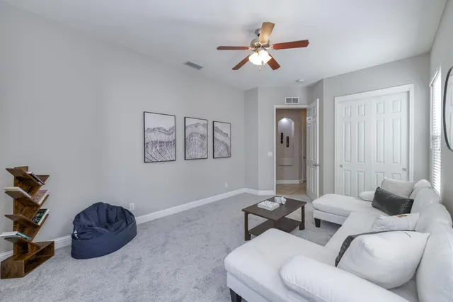 a living room with furniture and a chandelier