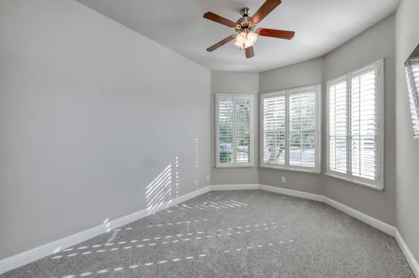 a view of room with a ceiling fan and window