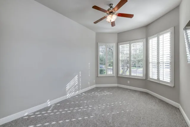 a view of room with a ceiling fan and window