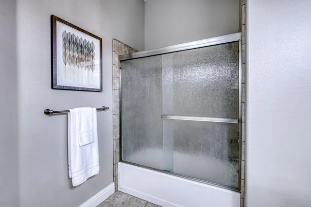 a bathroom with a glass shower door