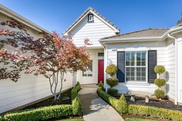 a front view of a house with garden