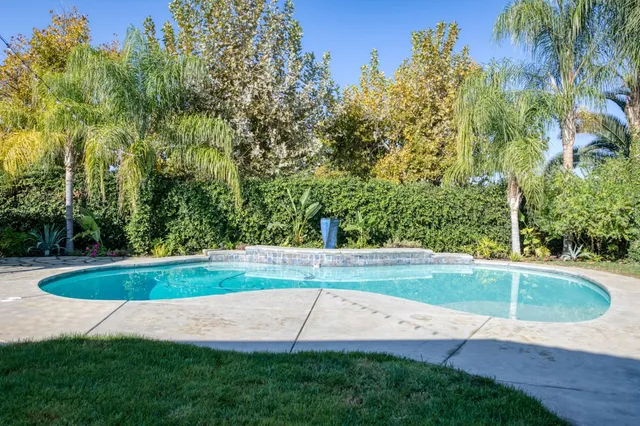 a view of a backyard with swimming pool
