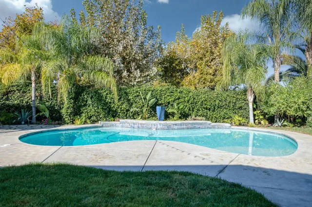 a view of a backyard with swimming pool