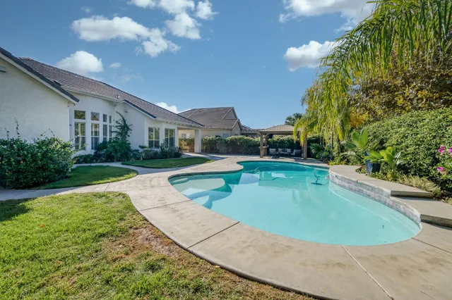 a view of a patio with a table and chairs under an umbrella