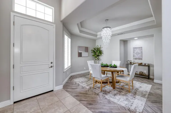 a view of a dining room with furniture and chandelier