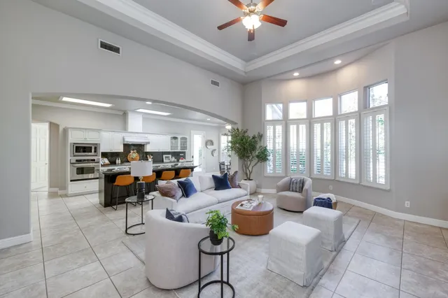 a living room with furniture and a chandelier