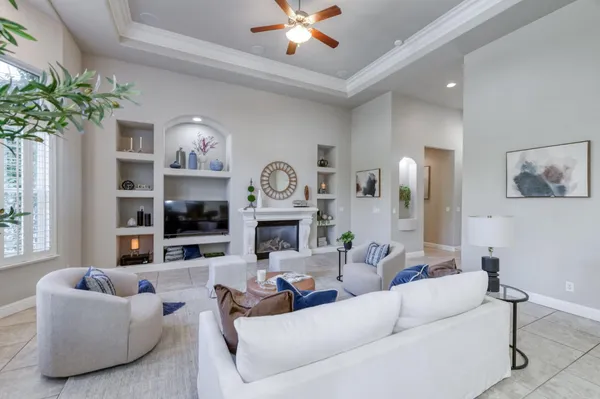 a living room with furniture and a chandelier