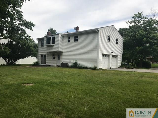 22 Jean Road East Brunswick, NJ 08816 - Photo 14 of 18 a view of a white house with a yard