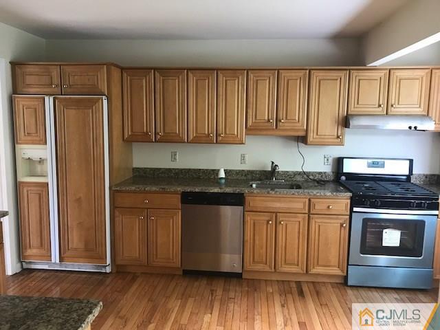 22 Jean Road East Brunswick, NJ 08816 - Photo 3 of 18 a kitchen with granite countertop wooden cabinets and a stainless steel appliances