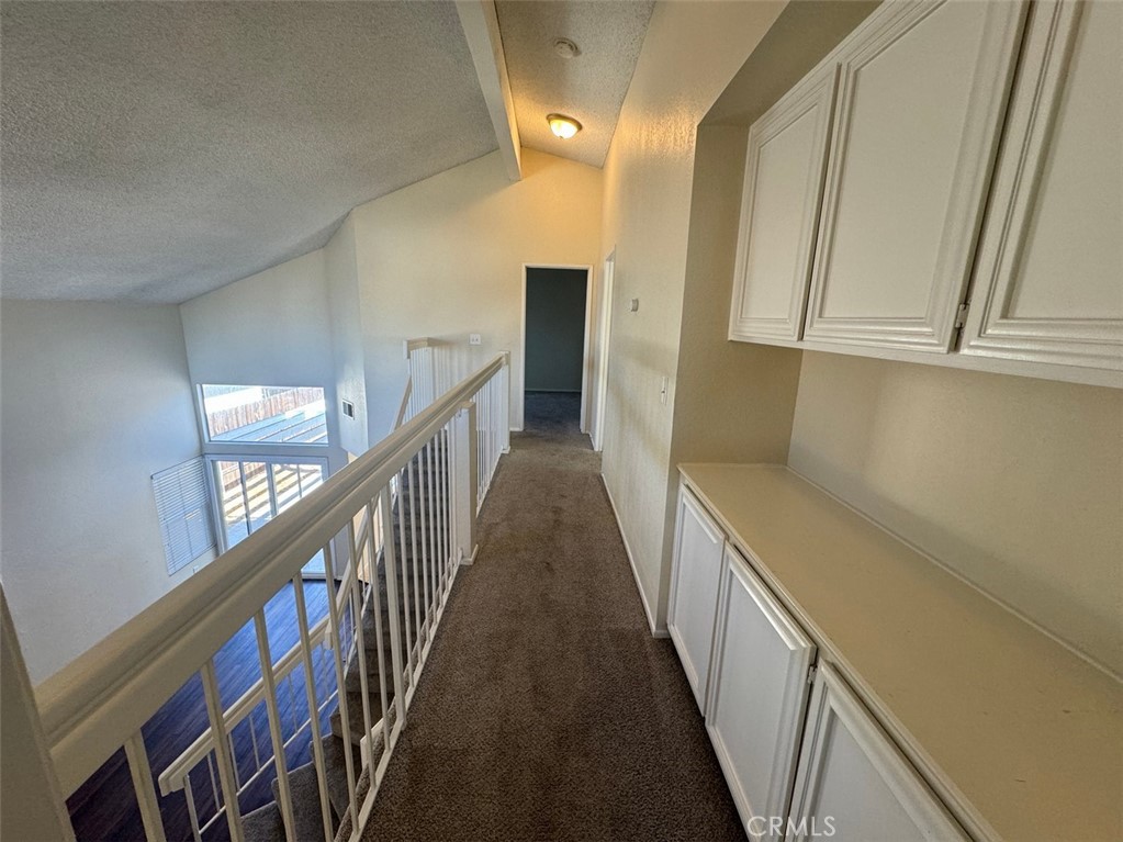 13080 Mohican Drive Moreno Valley, CA 92555 - Photo 23 of 38 a view of a hallway with wooden floor and staircase