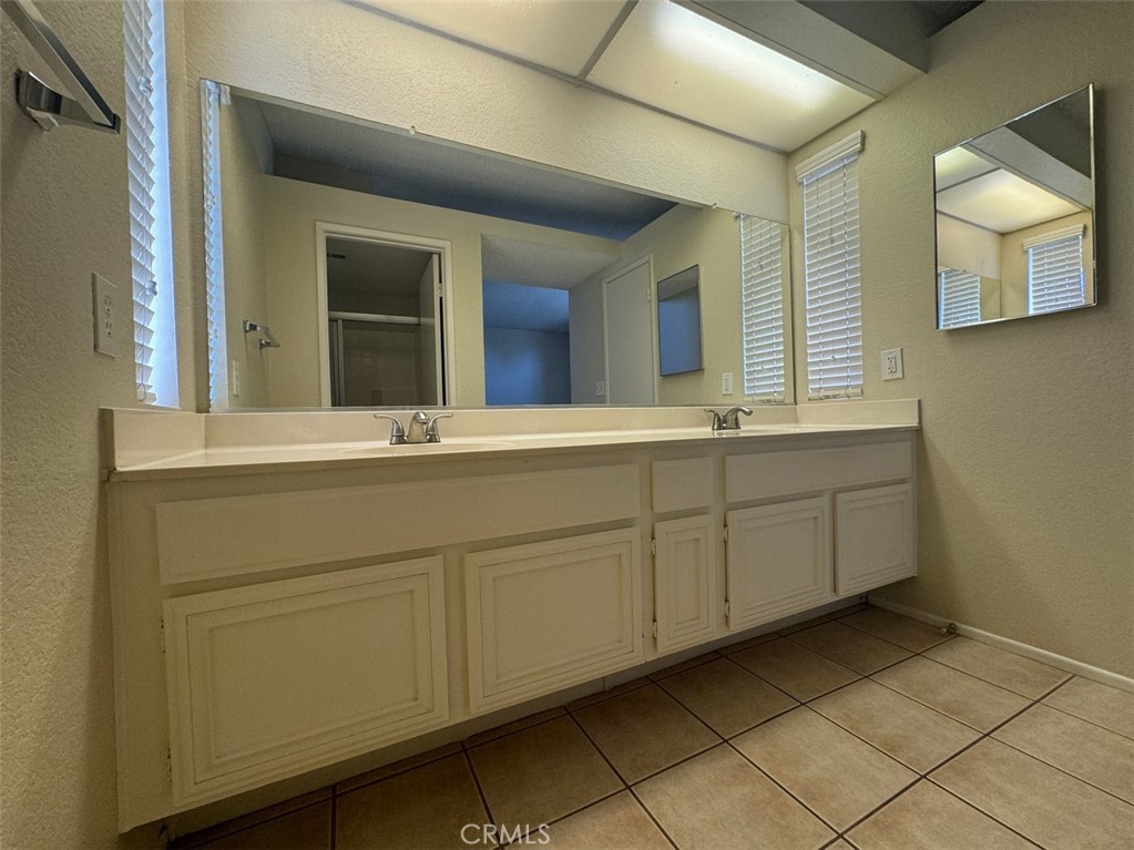 13080 Mohican Drive Moreno Valley, CA 92555 - Photo 26 of 38 a bathroom with a sink and mirror