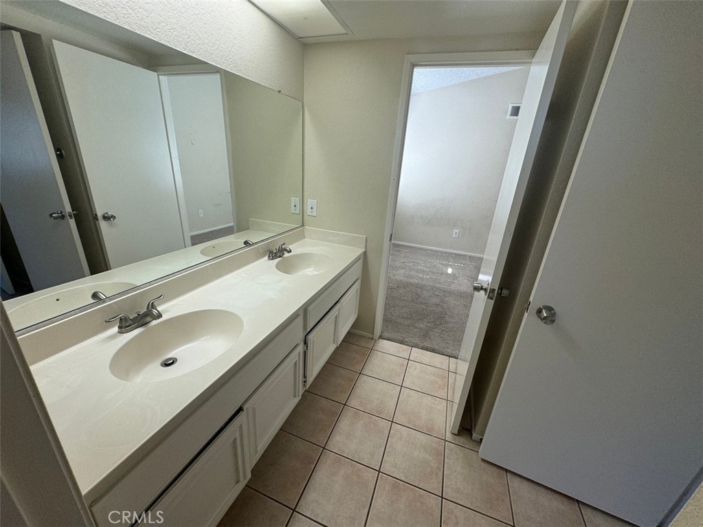 13080 Mohican Drive Moreno Valley, CA 92555 - Photo 31 of 38 a bathroom with a sink and a mirror