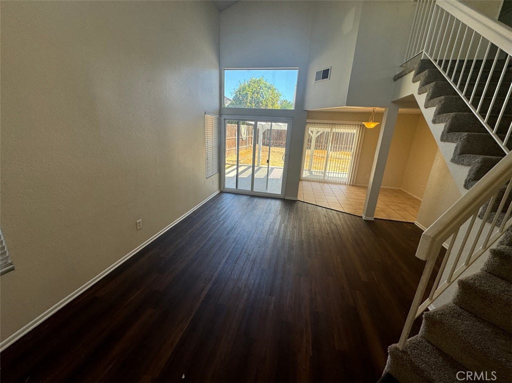 13080 Mohican Drive Moreno Valley, CA 92555 - Photo 6 of 38 a view of an empty room with wooden floor and a window