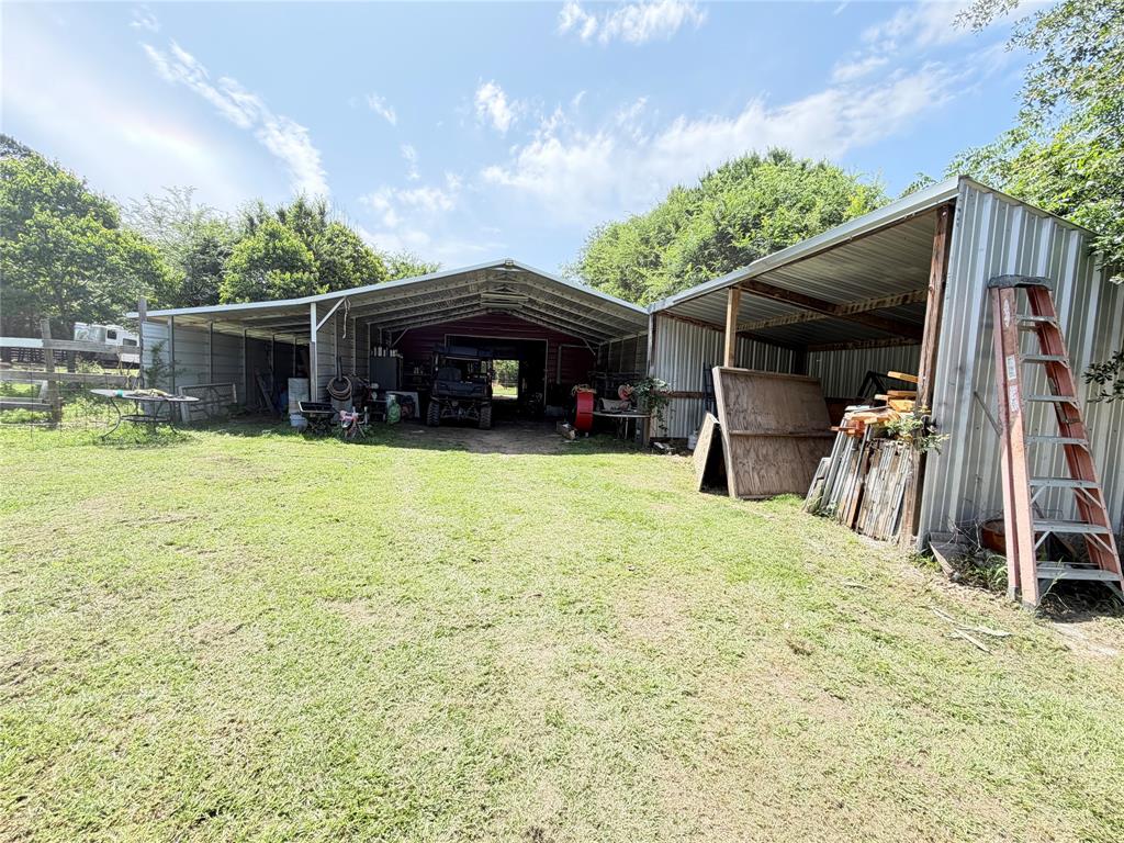8261 County Road 381 Tyler, TX 75708 - Photo 37 of 40 a view of a house with floor to ceiling windows and a yard