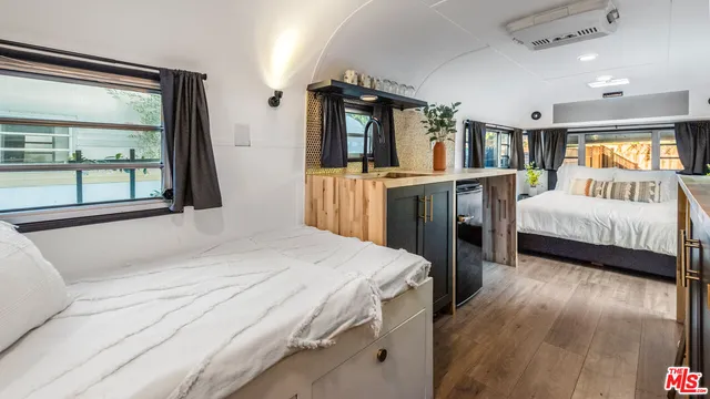 a bedroom with a large bed and a large window