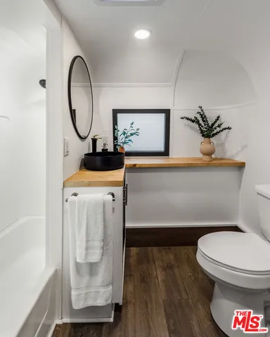 a bathroom with a toilet a sink and a mirror