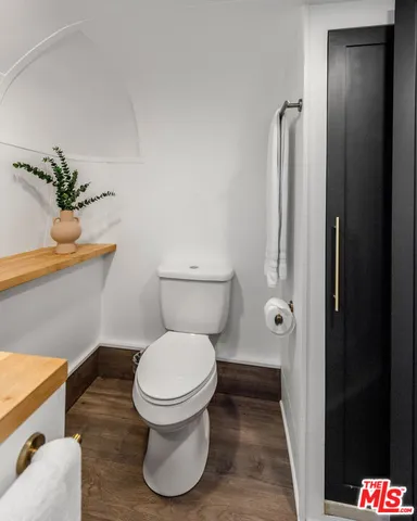 a bathroom with a toilet and a shower