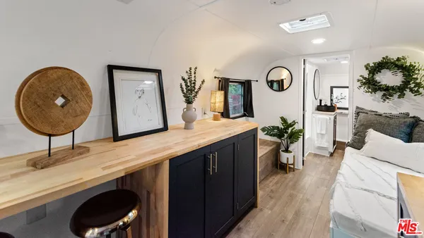 a living room with furniture and a mirror