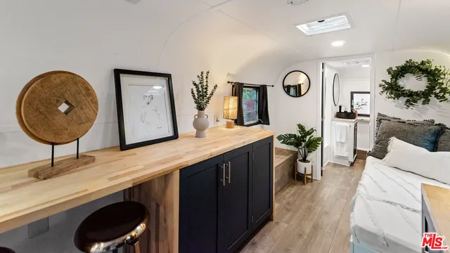 a living room with furniture and a mirror