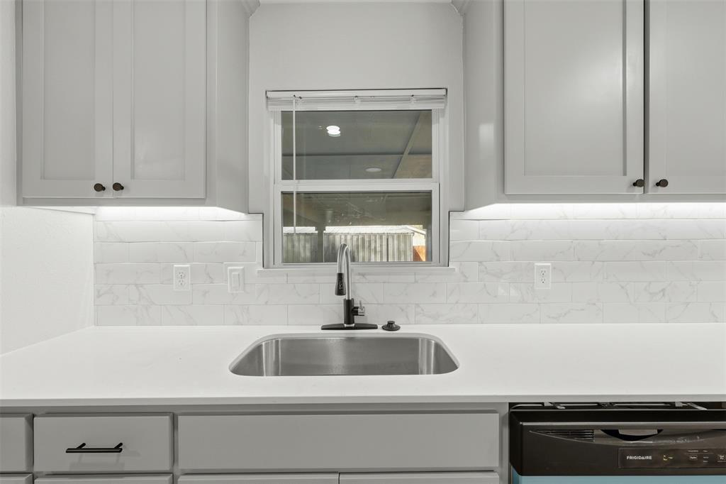 502 Madison Street Cleburne, TX 76033 - Photo 11 of 30 farn house sink in kitchen over looking backyard.