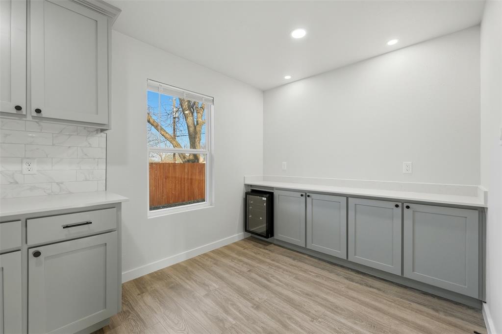 502 Madison Street Cleburne, TX 76033 - Photo 12 of 30 Kitchen area with built in wine fridge and extra cabinet space.
