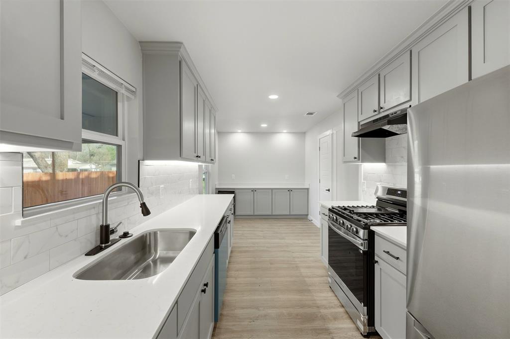 502 Madison Street Cleburne, TX 76033 - Photo 6 of 30 Fully updated kitchen with granite countertops, a tasteful backsplash and all new appliances.