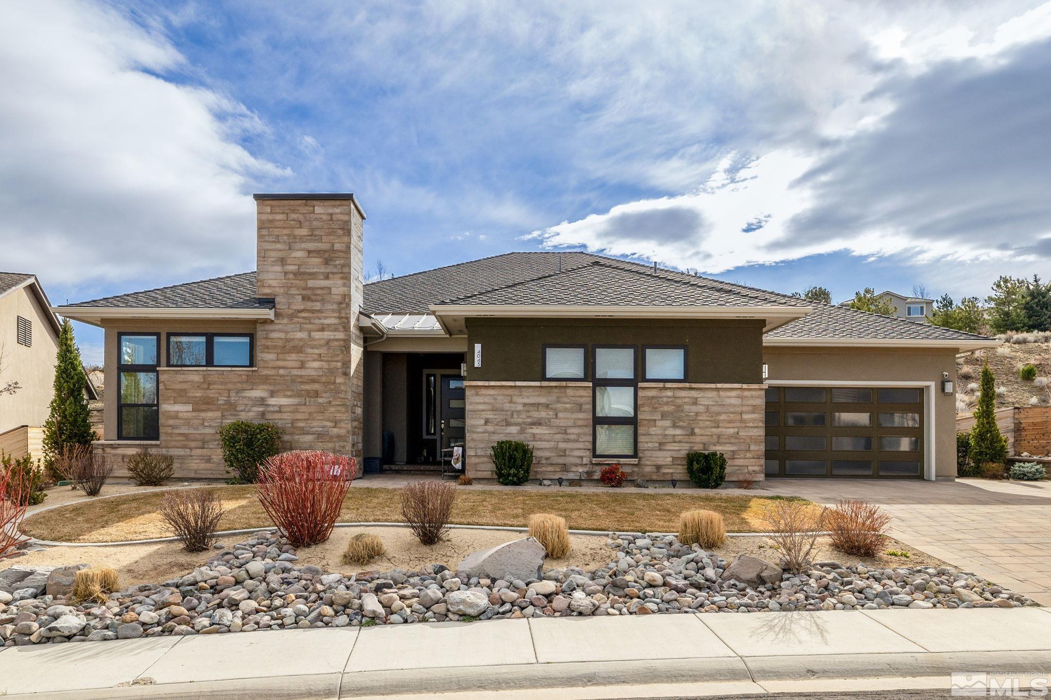 4045 Whispering Pine Loop Reno, NV 89519 - Photo 1 of 39 a front view of a house with garden