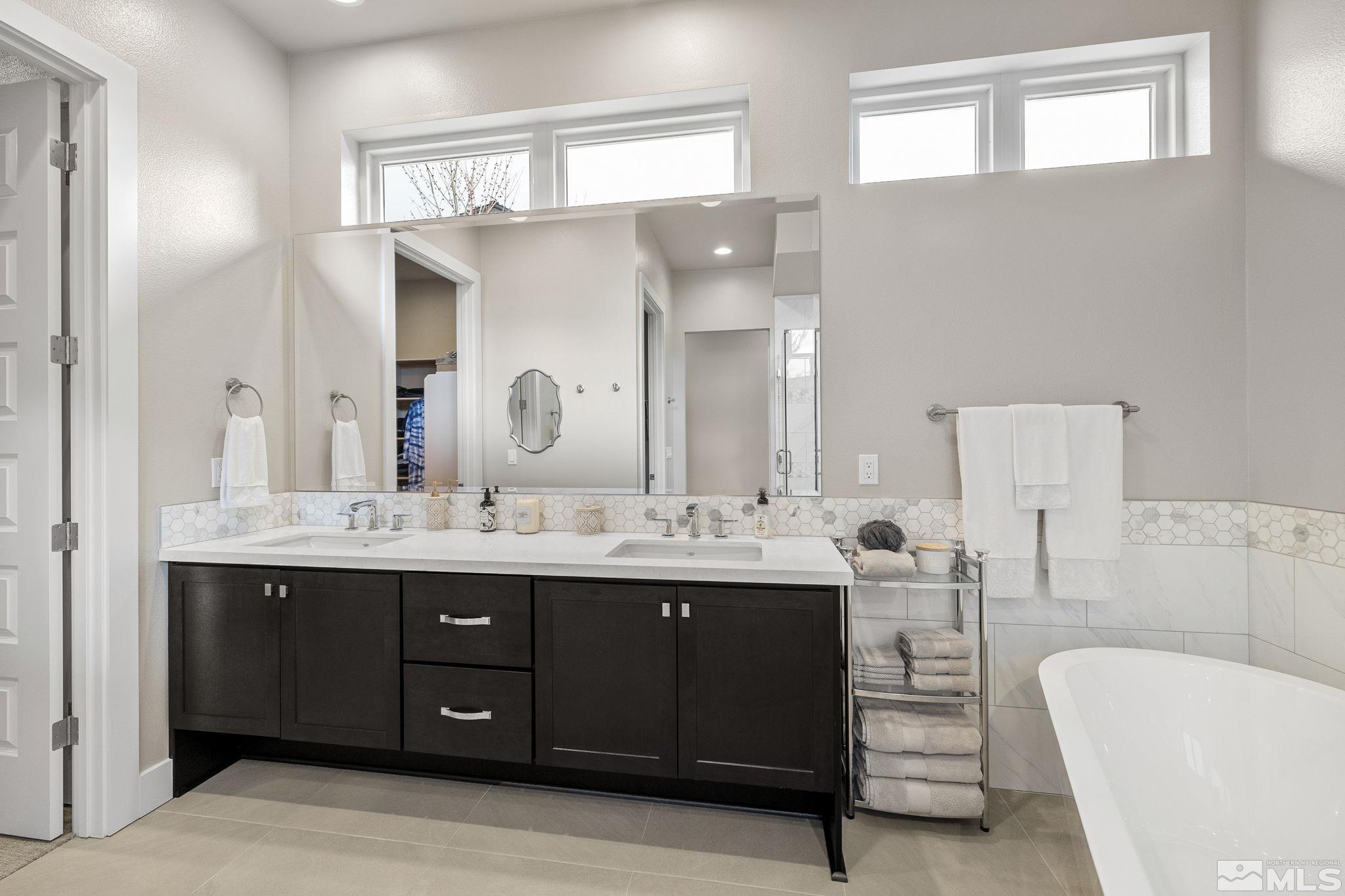4045 Whispering Pine Loop Reno, NV 89519 - Photo 19 of 39 a bathroom with a double vanity sink and a mirror
