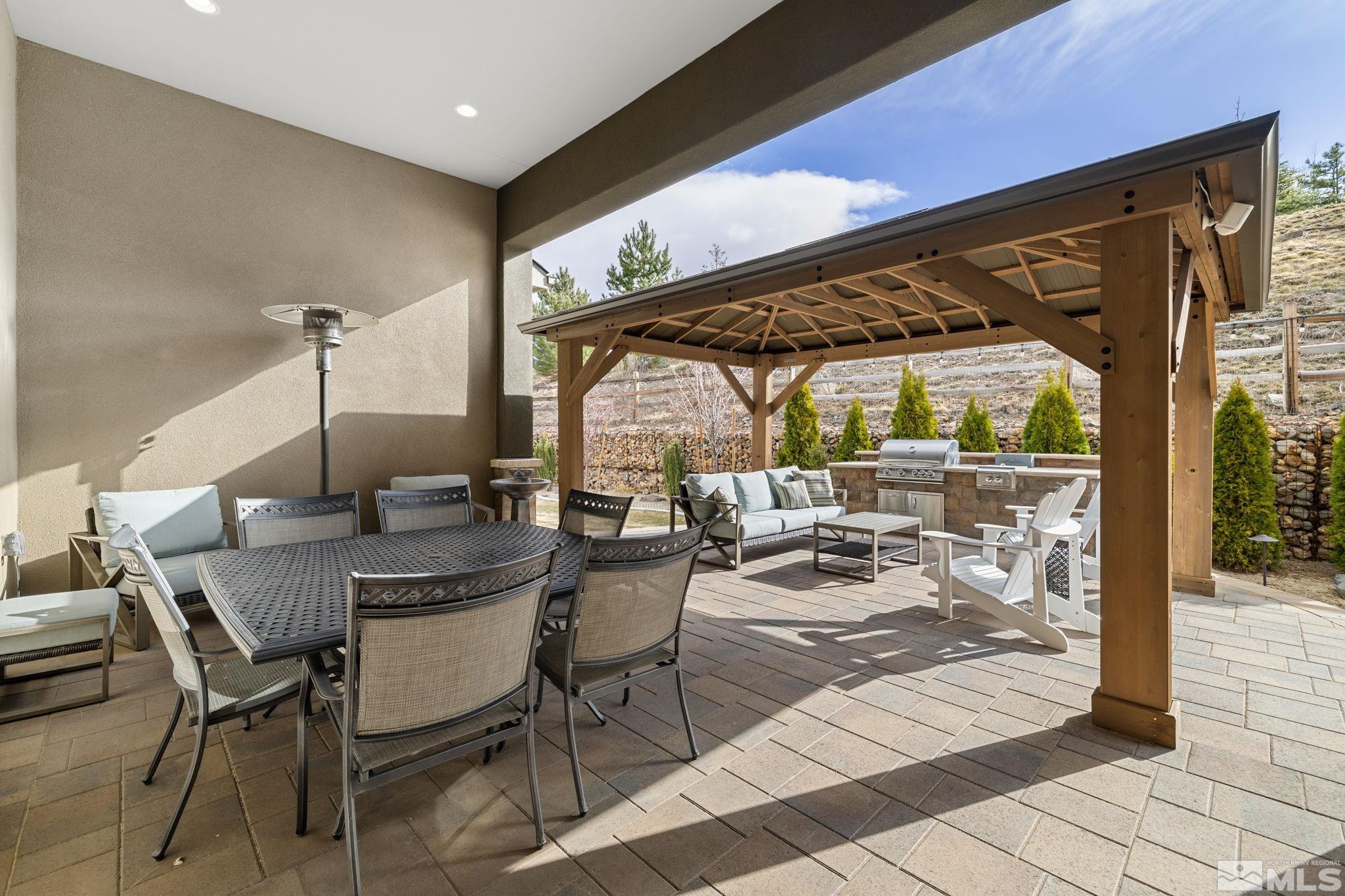4045 Whispering Pine Loop Reno, NV 89519 - Photo 30 of 39 a view of a patio with table and chairs and potted plants