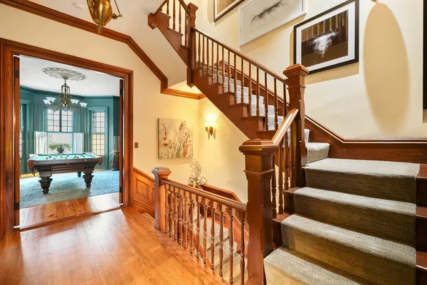 a view of an entryway with wooden floor and a front door