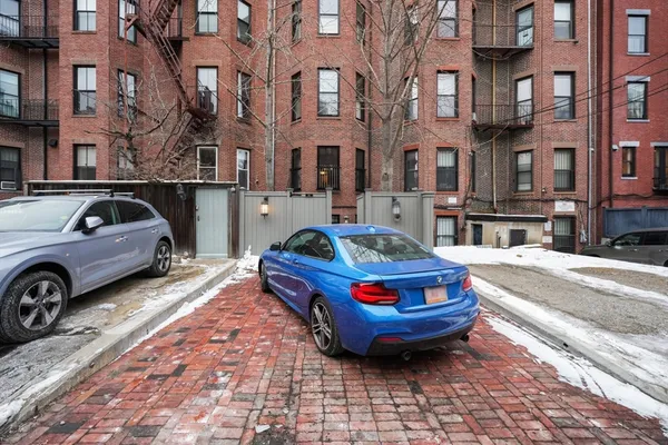 a car parked in front of a brick house